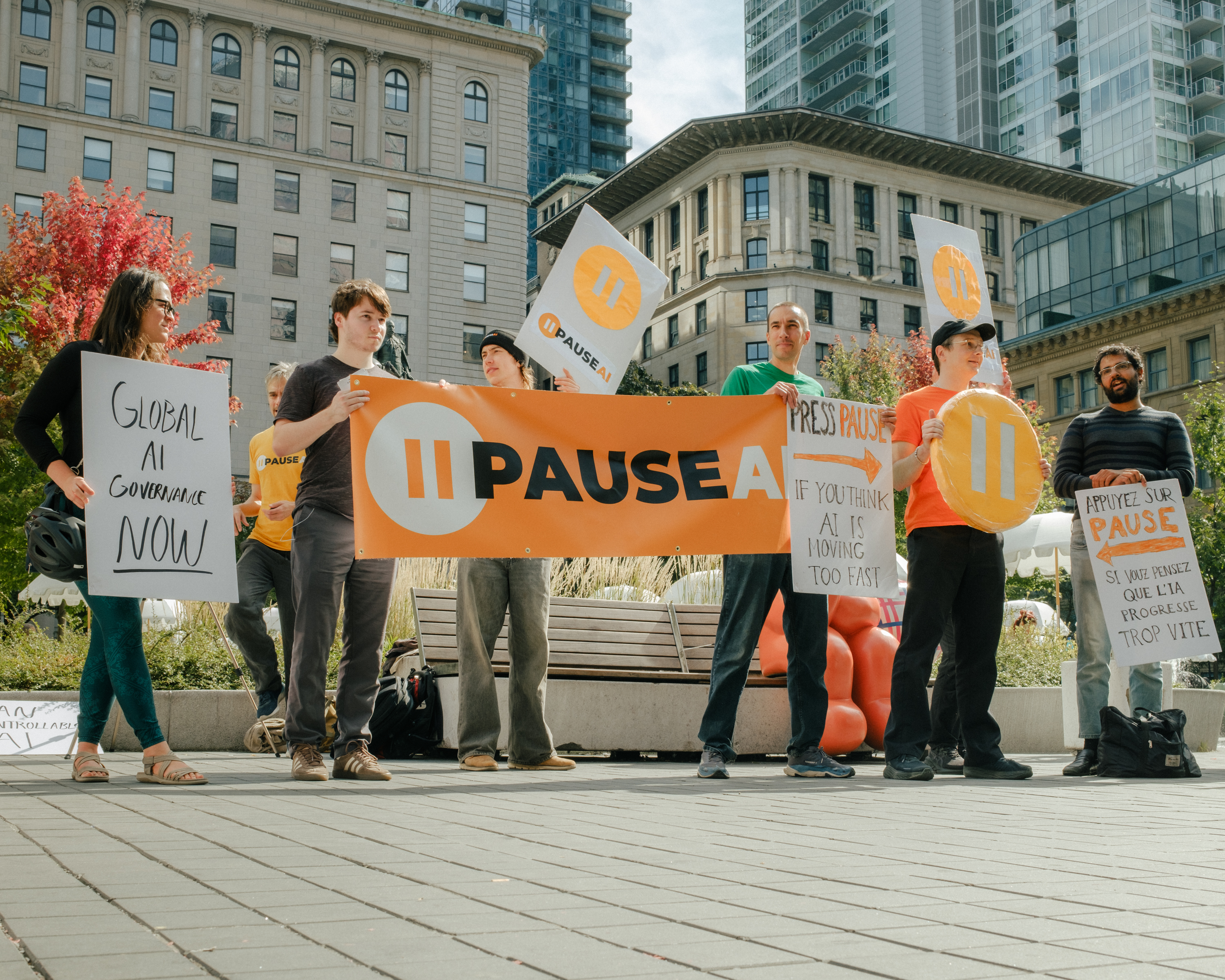 Demonstrators holding a PauseAI banner and signs at Phillips Square
